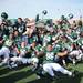 The Eastern Michigan football team poses for a photograph as they celebrate winning the Michigan MAC Football Championship trophy after being Western 14-10 at Rynearson Stadium on Saturday afternoon. Melanie Maxwell I AnnArbor.com